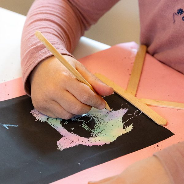 a child drawing with a stick